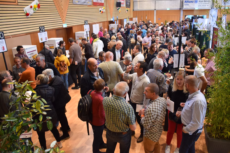 L'allée du salon animée par les visiteurs entre les stands de vin.